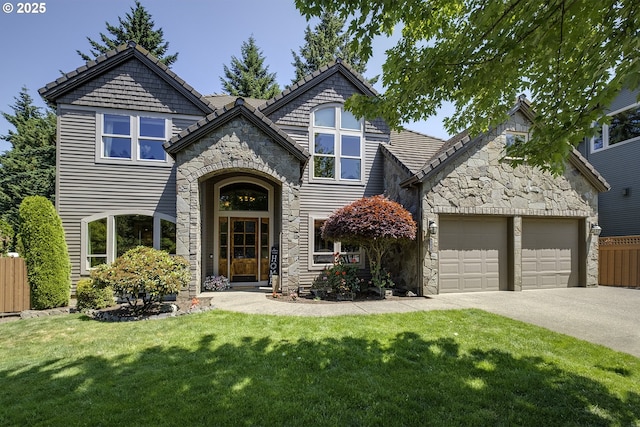 21540 SW 110th Pl, Tualatin, OR 97062 - view of front of house with stone siding, driveway, and an attached garage