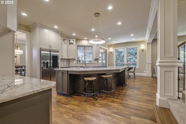 21540 SW 110th Pl, Tualatin, OR 97062 - kitchen featuring appliances with stainless steel finishes, dark wood-type flooring, white cabinets, recessed lighting, and a center island