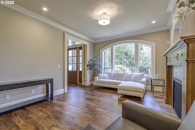 21540 SW 110th Pl, Tualatin, OR 97062 - living room featuring dark wood finished floors, crown molding, a textured ceiling, a fireplace, and baseboards