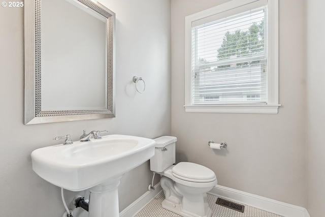 bathroom with tile patterned flooring and toilet