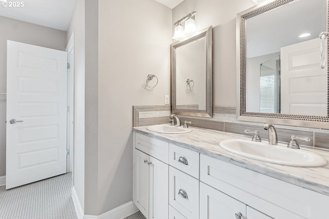 bathroom featuring vanity and decorative backsplash