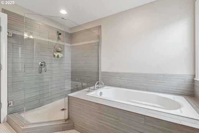 bathroom with separate shower and tub