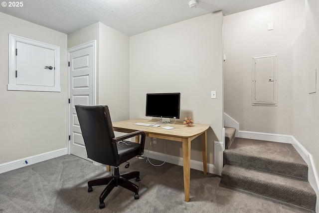 office featuring carpet flooring, electric panel, and a textured ceiling