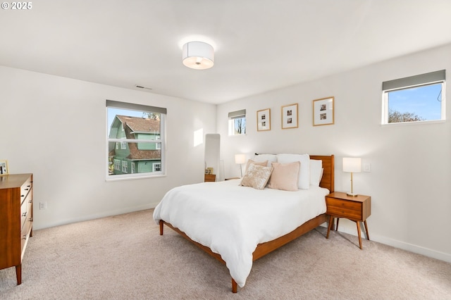 carpeted bedroom featuring multiple windows