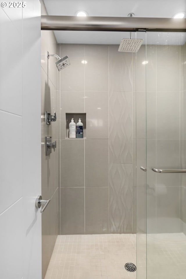 bathroom featuring a shower with shower door