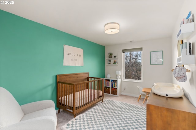 carpeted bedroom featuring a crib