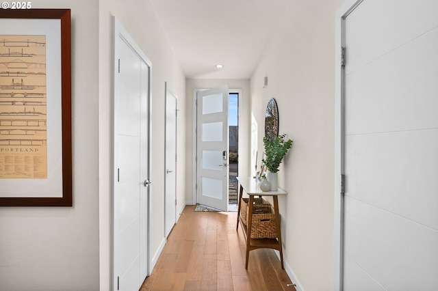 hall with light hardwood / wood-style floors