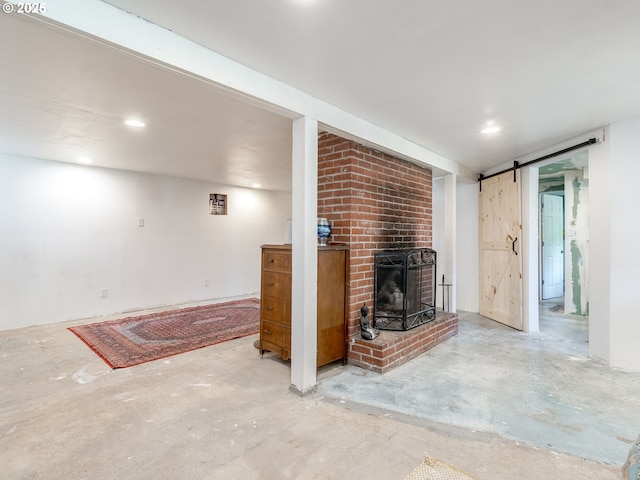 4312 NE 40th St, Vancouver, WA 98661 - unfurnished living room with unfinished concrete floors, recessed lighting, a barn door, and a brick fireplace