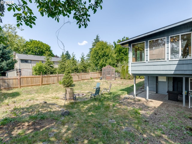 4312 NE 40th St, Vancouver, WA 98661 - fenced backyard featuring an outdoor structure, an outdoor fire pit, and a patio area