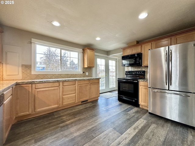 kitchen with french doors, dark wood-type flooring, light stone counters, tasteful backsplash, and black appliances