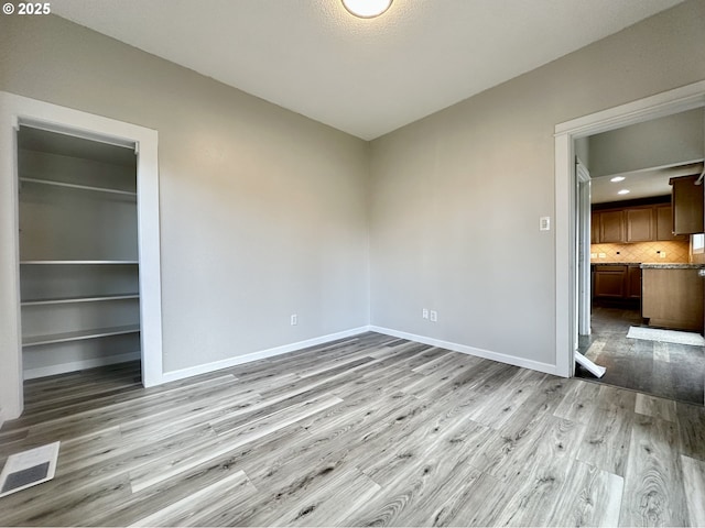 spare room featuring light wood-type flooring