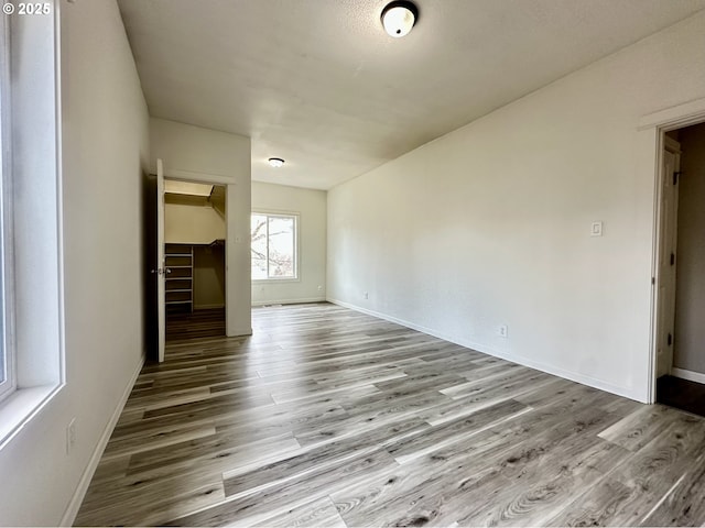 unfurnished room with light wood-type flooring