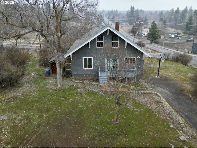 back of house with a lawn