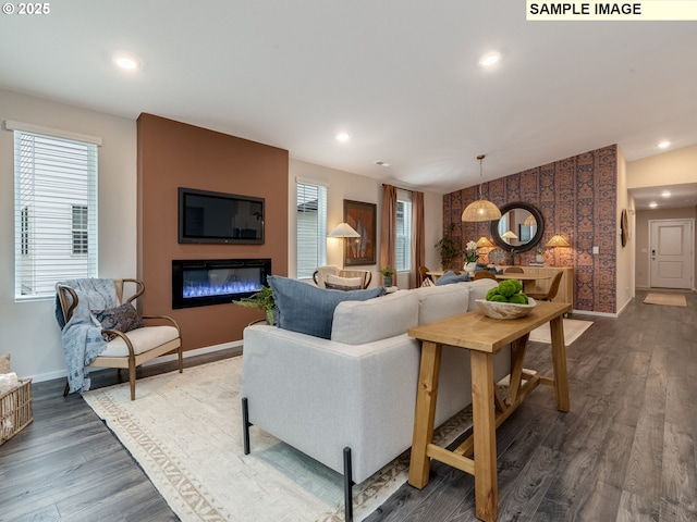kitchen with dark wood-style flooring, light countertops, a sink, vaulted ceiling, and stainless steel dishwasher
