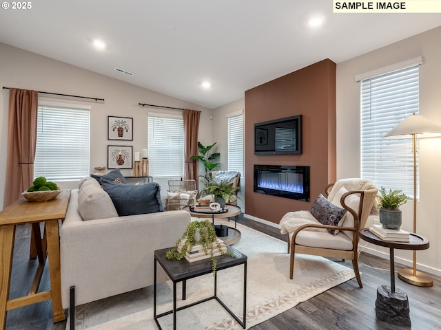 clothes washing area with washing machine and clothes dryer, baseboards, laundry area, and light wood-style floors