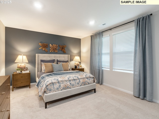 bedroom featuring a closet, carpet flooring, a walk in closet, baseboards, and visible vents