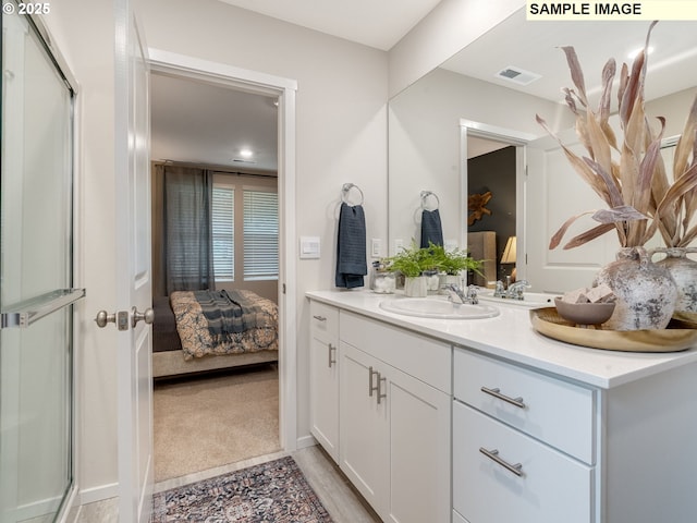 full bath with visible vents, baseboards, wood finished floors, vanity, and a stall shower