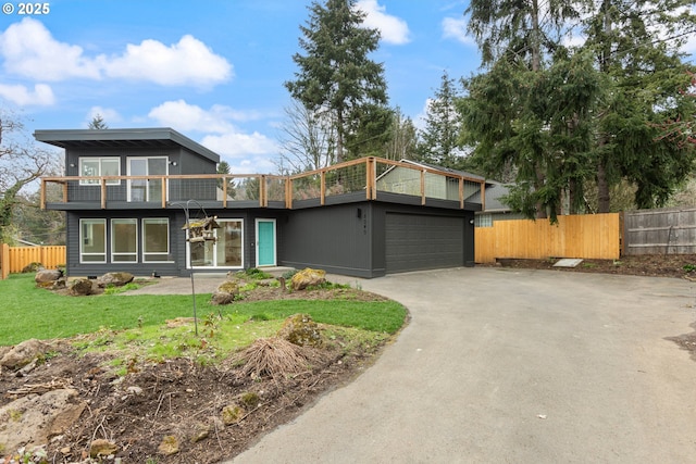 view of front of home featuring a front yard, fence, and driveway