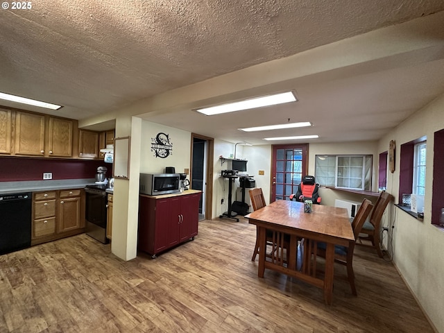 440 N Mountain Blvd, Mount Vernon, OR 97865 - kitchen featuring stainless steel microwave, black dishwasher, range with electric stovetop, wood finished floors, and a textured ceiling