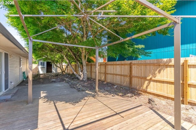 wooden terrace featuring a fenced backyard