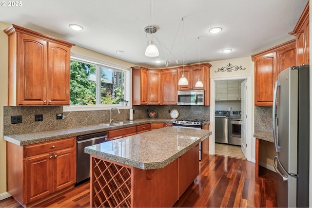 1145 NW 22nd Ave, Camas, WA 98607 - kitchen with appliances with stainless steel finishes, dark wood-style floors, a sink, a center island, and hanging light fixtures