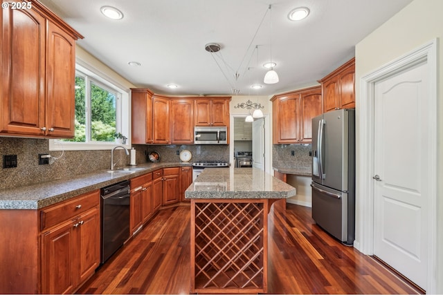 1145 NW 22nd Ave, Camas, WA 98607 - kitchen featuring appliances with stainless steel finishes, a sink, dark wood-style flooring, a kitchen island, and backsplash
