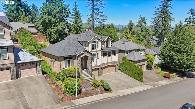 1145 NW 22nd Ave, Camas, WA 98607 - craftsman-style home featuring stone siding, driveway, an attached garage, a shingled roof, and board and batten siding