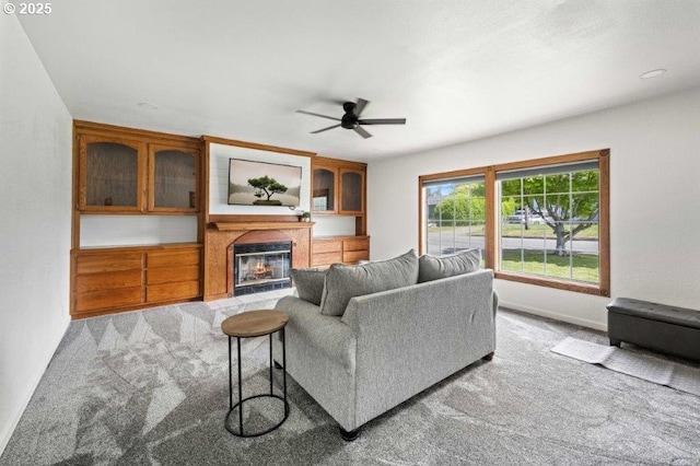 3060 Pine St, North Bend, OR 97459 - living area with light carpet, a ceiling fan, a glass covered fireplace, and baseboards
