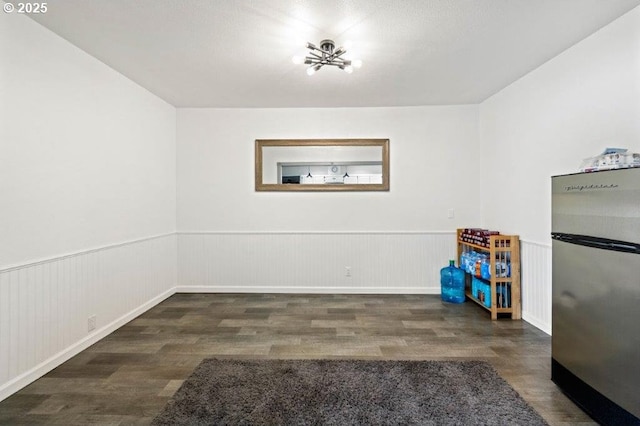 3060 Pine St, North Bend, OR 97459 - unfurnished dining area with wood finished floors, a wainscoted wall, and a chandelier