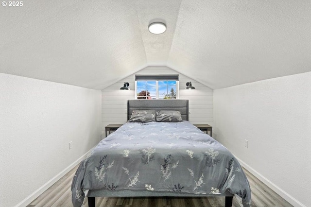 3060 Pine St, North Bend, OR 97459 - bedroom featuring wood finished floors, baseboards, vaulted ceiling, and a textured ceiling