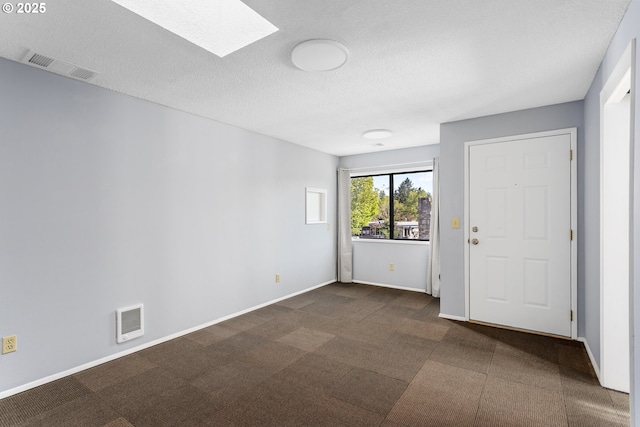 2125 NE 48th Ave, Portland, OR 97213 - empty room with a skylight, dark colored carpet, baseboards, and a textured ceiling