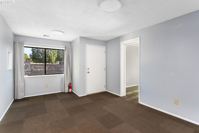 2125 NE 48th Ave, Portland, OR 97213 - unfurnished room featuring a textured ceiling, baseboards, and dark colored carpet