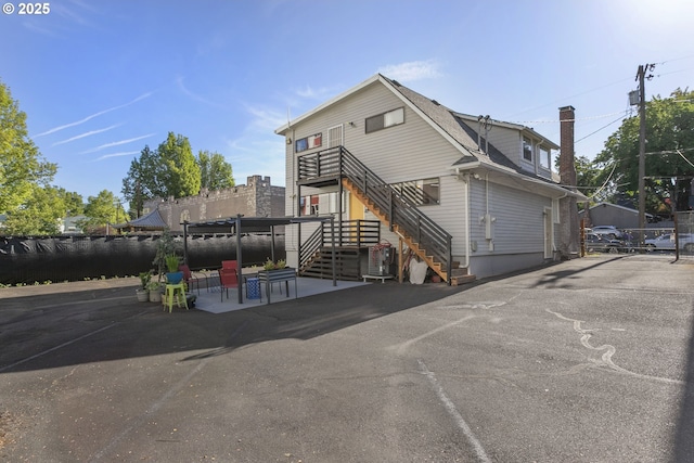 2125 NE 48th Ave, Portland, OR 97213 - view of front of property featuring stairs, a chimney, central AC, and a patio