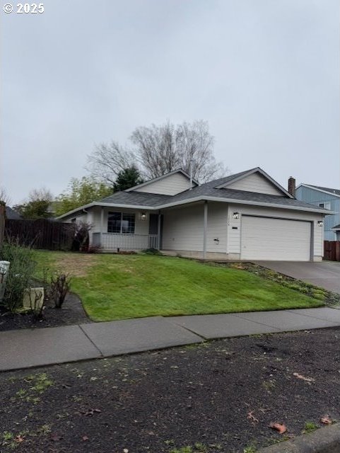 view of front of property with a garage and a front lawn