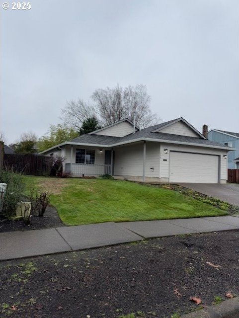 view of front of house featuring a garage and a front lawn