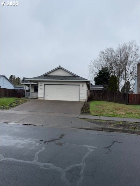 single story home featuring a garage and a front yard