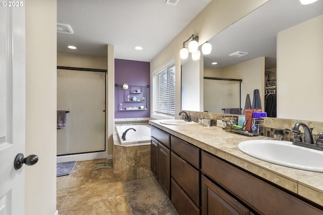 4219 NE 157th Ct, Vancouver, WA 98682 - bathroom featuring a shower stall, a garden tub, a sink, and a walk in closet