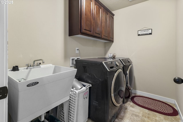 4219 NE 157th Ct, Vancouver, WA 98682 - washroom featuring baseboards, independent washer and dryer, a sink, and cabinet space