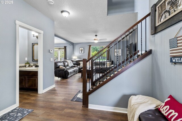 4219 NE 157th Ct, Vancouver, WA 98682 - stairway with ceiling fan, a textured ceiling, wood finished floors, and baseboards