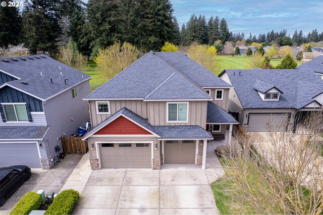 4219 NE 157th Ct, Vancouver, WA 98682 - craftsman inspired home featuring concrete driveway, roof with shingles, board and batten siding, and stone siding