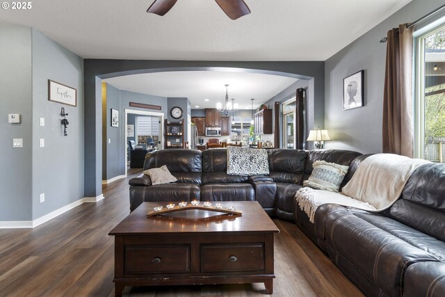 4219 NE 157th Ct, Vancouver, WA 98682 - living area featuring arched walkways, baseboards, ceiling fan with notable chandelier, and dark wood finished floors