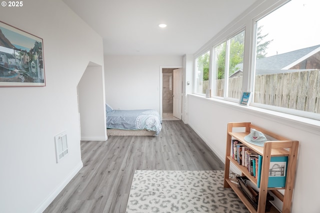bedroom featuring wood finished floors, baseboards, and recessed lighting