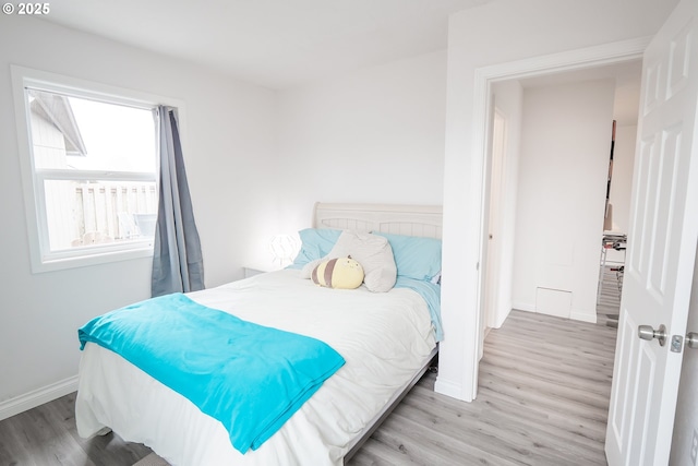 bedroom with wood finished floors and baseboards