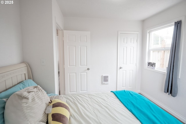 bedroom featuring heating unit