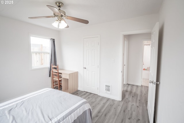 bedroom with light wood-type flooring, baseboards, and a ceiling fan