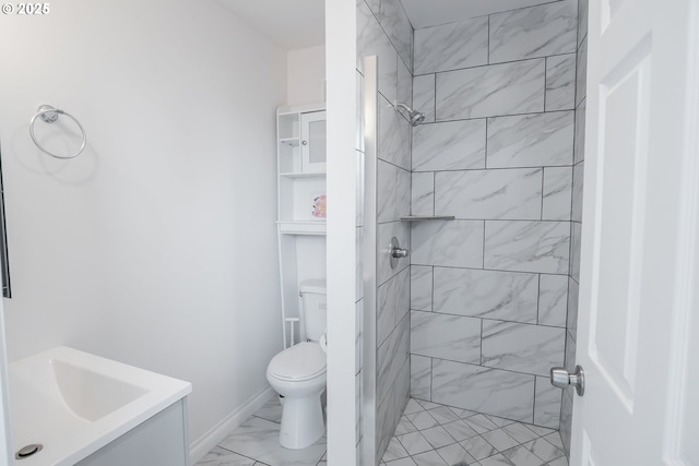 full bath featuring a tile shower, marble look tile flooring, toilet, and vanity