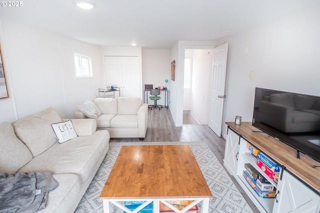 living room featuring light wood-style flooring and recessed lighting