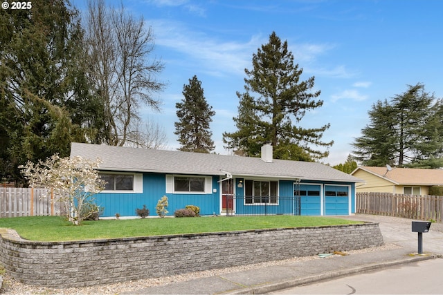 ranch-style house featuring a front yard, fence, driveway, a chimney, and a garage