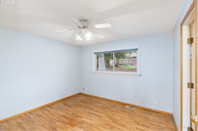 unfurnished room featuring a ceiling fan, baseboards, and wood finished floors