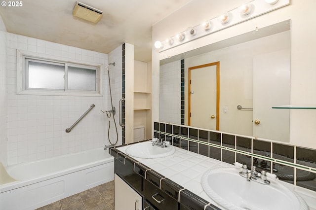 bathroom featuring tile patterned flooring, double vanity, shower / bathtub combination, and a sink